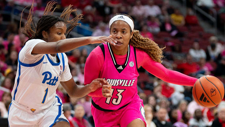 Louisville Cardinals guard Merissah Russell (13) makes her way around Pittsburgh Panthers guard Aaryn Battle (1) during their game on Sunday, Jan. 28, 2024 at KFC YUM Center.