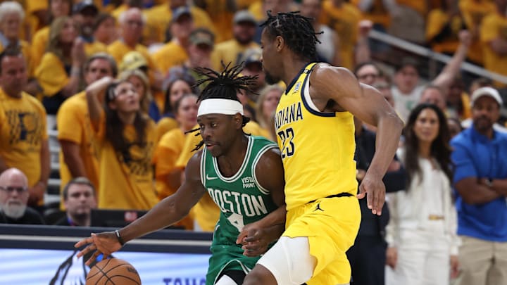 May 25, 2024; Indianapolis, Indiana, USA; Boston Celtics guard Jrue Holiday (4) brings the ball up court against Indiana Pacers forward Aaron Nesmith (23) during the fourth quarter of game three of the eastern conference finals in the 2024 NBA playoffs at Gainbridge Fieldhouse. Mandatory Credit: Trevor Ruszkowski-USA TODAY Sports