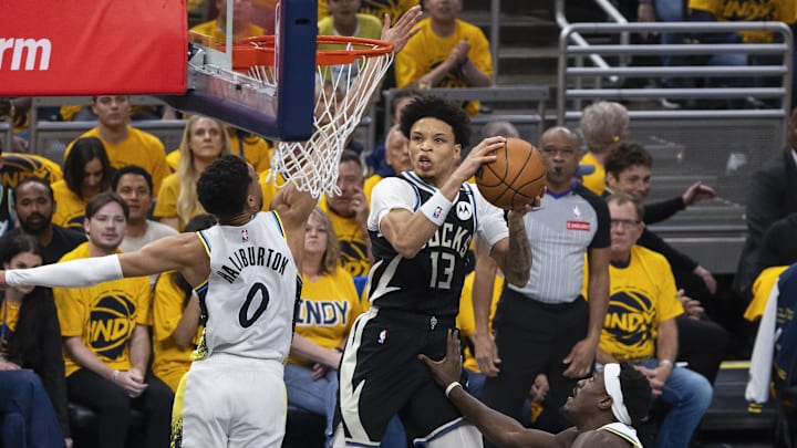 Apr 19, 2025; Indianapolis, Indiana, USA;  Milwaukee Bucks guard Ryan Rollins (13) shoots the ball while Indiana Pacers guard Tyrese Haliburton (0) defends in the first half at Gainbridge Fieldhouse. Mandatory Credit: Trevor Ruszkowski-Imagn Images