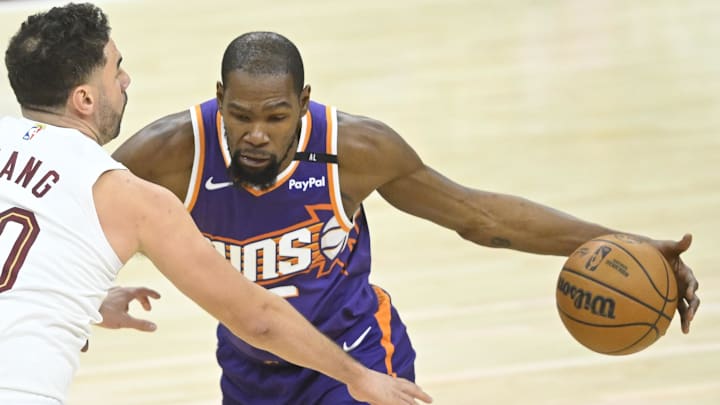 Jan 20, 2025; Cleveland, Ohio, USA; Phoenix Suns forward Kevin Durant (35) dribbles beside Cleveland Cavaliers forward Georges Niang (20) in the third quarter at Rocket Mortgage FieldHouse. Mandatory Credit: David Richard-Imagn Images
