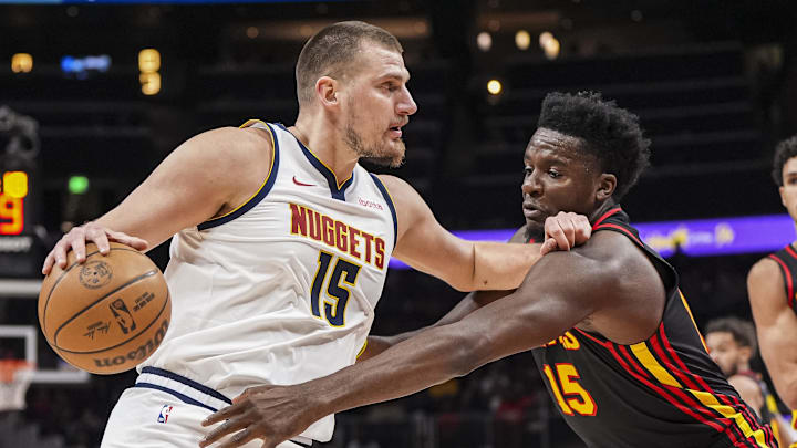 Dec 8, 2024; Atlanta, Georgia, USA; Denver Nuggets center Nikola Jokic (15) is defended by Atlanta Hawks center Clint Capela (15) during the first quarter at State Farm Arena. Mandatory Credit: Dale Zanine-Imagn Images