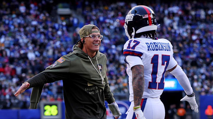 Nov 16, 2025; East Rutherford, New Jersey, USA; New York Giants injured quarterback Jaxson Dart celebrates with wide receiver Wan'Dale Robinson (17) on the sideline during the second quarter of the game against the Green Bay Packers at MetLife Stadium. Nov 16, 2025; East Rutherford, New Jersey, USA; New York Giants injured quarterback Jaxson Dart celebrates with wide receiver Wan'Dale Robinson (17) on the sideline during the second quarter of the game against the Green Bay Packers at MetLife Stadium.