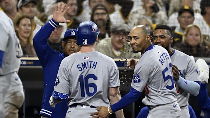 Oct 9, 2024; San Diego, California, USA; Los Angeles Dodgers catcher Will Smith (16) celebrates with shortstop Mookie Betts (50) and manager Dave Roberts (30) after hitting a two-run home run in the third inning against the San Diego Padres during game four of the NLDS for the 2024 MLB Playoffs at Petco Park. Mandatory Credit: Denis Poroy-Imagn Images Oct 9, 2024; San Diego, California, USA; Los Angeles Dodgers catcher Will Smith (16) celebrates with shortstop Mookie Betts (50) and manager Dave Roberts (30) after hitting a two-run home run in the third inning against the San Diego Padres during game four of the NLDS for the 2024 MLB Playoffs at Petco Park. Mandatory Credit: Denis Poroy-Imagn Images