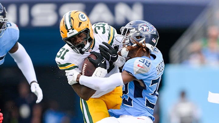 Tennessee Titans cornerback L'Jarius Sneed tackles Green Bay Packers running back Emanuel Wilson. Mandatory Credit: Steve Roberts-Imagn Images