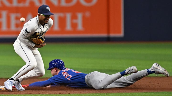Apr 7, 2026; St. Petersburg, Florida, USA;  Tampa Bay Rays second baseman Ben Williamson (15) misplays the throw as Chicago Cubs centerfielder Pete Crow-Armstrong (4) slides into second base in the third inning at Tropicana Field. 
