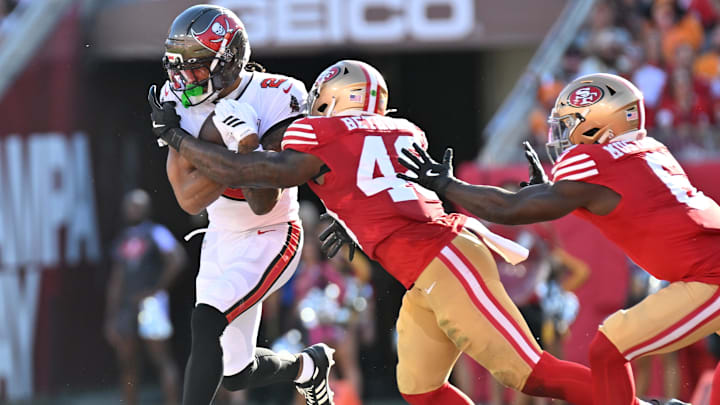  Oct 12, 2025; Tampa, Florida, USA: Tampa Bay Buccaneers wide receiver Emeka Egbuka (2) runs for a gain past San Francisco 49ers linebacker Tatum Bethune (48) during the second quarter at Raymond James Stadium. Mandatory Credit: Jonathan Dyer-Imagn Images