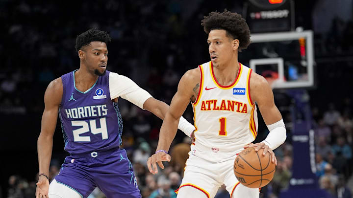 Feb 11, 2026; Charlotte, North Carolina, USA; Atlanta Hawks forward Jalen Johnson (1) handles the ball defended by Charlotte Hornets forward Brandon Miller (24) during first quarter at Spectrum Center. Mandatory Credit: Jim Dedmon-Imagn Images