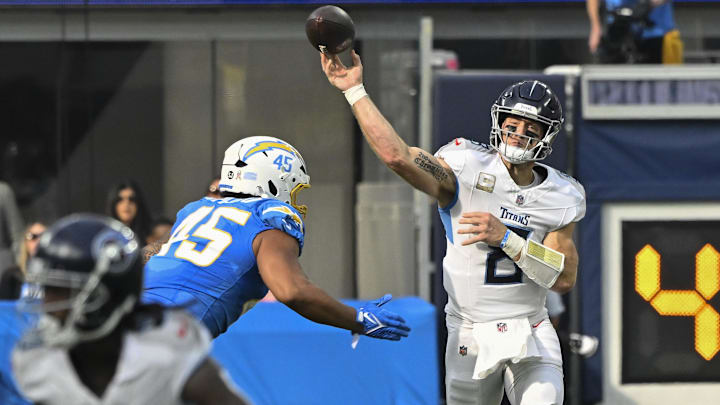 Nov 10, 2024; Inglewood, California, USA; Tennessee Titans quarterback Will Levis (8) throws a pass as he is pressured by Los Angeles Chargers linebacker Tuli Tuipulotu (45) during the second quarter at SoFi Stadium. Mandatory Credit: Robert Hanashiro-Imagn Images