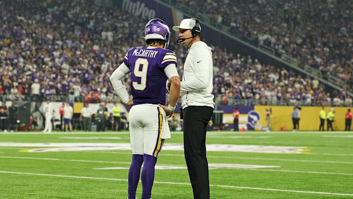 Sep 14, 2025; Minneapolis, Minnesota, USA; Minnesota Vikings quarterback J.J. McCarthy (9) speaks with Minnesota Vikings head coach Kevin O'Connell during the first half against the Atlanta Falcons at U.S. Bank Stadium. Mandatory Credit: Matt Krohn-Imagn Images