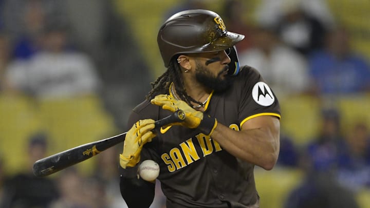 Jun 19, 2025; Los Angeles, California, USA;   San Diego Padres right fielder Fernando Tatis Jr. (23) reacts as he is hit by a pitch in the eighth inning against the Los Angeles Dodgers at Dodger Stadium. Mandatory Credit: Jayne Kamin-Oncea-Imagn Images