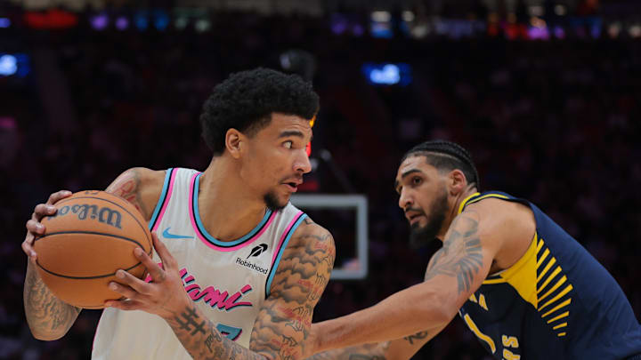 Feb 28, 2025; Miami, Florida, USA; Miami Heat center Kel'el Ware (7) protects the basketball from Indiana Pacers forward Obi Toppin (1) during the third quarter at Kaseya Center. Mandatory Credit: Sam Navarro-Imagn Images