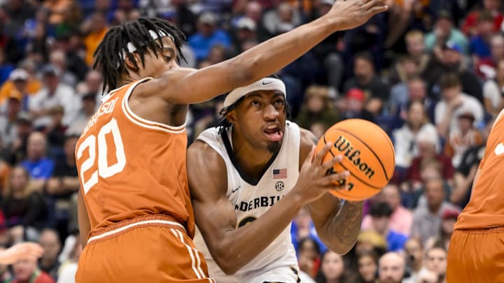 Mar 12, 2025; Nashville, TN, USA;  Vanderbilt Commodores guard MJ Collins Jr. (2) goes under the arm of Texas Longhorns guard Tre Johnson (20) during the first half at Bridgestone Arena. Mandatory Credit: Steve Roberts-Imagn Images