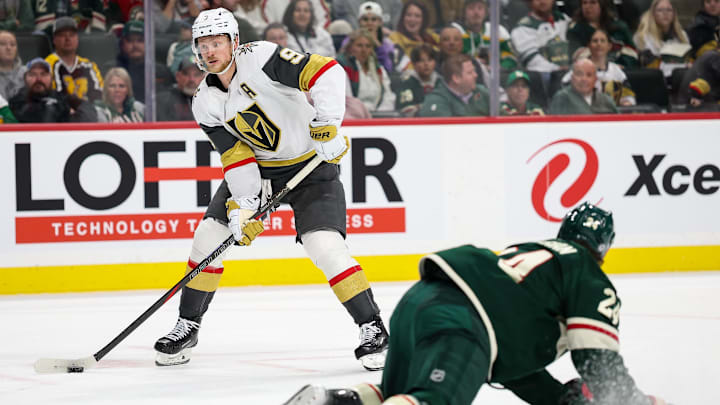 Mar 25, 2025; Saint Paul, Minnesota, USA; Vegas Golden Knights center Jack Eichel (9) skates with the puck as Minnesota Wild defenseman Zach Bogosian (24) defends during the third period at Xcel Energy Center. Mandatory Credit: Matt Krohn-Imagn Images