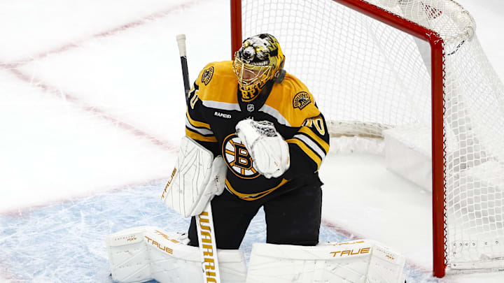 Dec 21, 2024; Boston, Massachusetts, USA; Boston Bruins goaltender Joonas Korpisalo (70) fights off a shot by his mask during the second period against the Buffalo Sabres at TD Garden. Mandatory Credit: Winslow Townson-Imagn Images