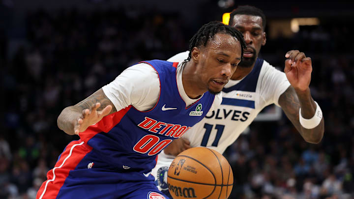 Mar 30, 2025; Minneapolis, Minnesota, USA; Detroit Pistons forward Ronald Holland II (00) drives towards the basket as Minnesota Timberwolves center Naz Reid (11) defends during the second quarter at Target Center. Mandatory Credit: Matt Krohn-Imagn Images