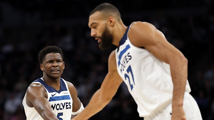 Mar 30, 2025; Minneapolis, Minnesota, USA; Minnesota Timberwolves guard Anthony Edwards (5) talks to center Rudy Gobert (27) during the first quarter against the Detroit Pistons at Target Center. Mandatory Credit: Matt Krohn-Imagn Images