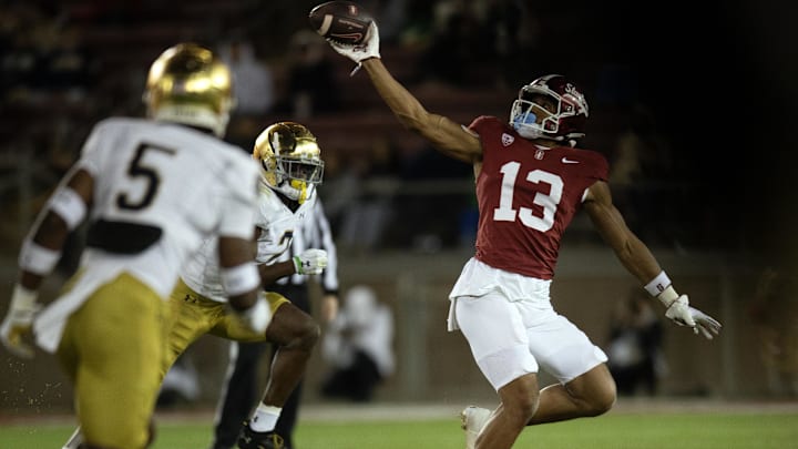 Nov 25, 2023; Stanford, California, USA; Stanford Cardinal wide receiver Elic Ayomanor (13) cannot quite hold a pass from quarterback Justin Lamson as he gets ahead of Notre Dame Fighting Irish safety DJ Brown (2) during the third quarter at Stanford Stadium. Mandatory Credit: D. Ross Cameron-Imagn Images