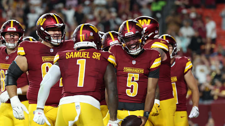 Washington Commanders star Jayden Daniels celebrates with teammates after scoring a touchdown against Cincinnati Bengals