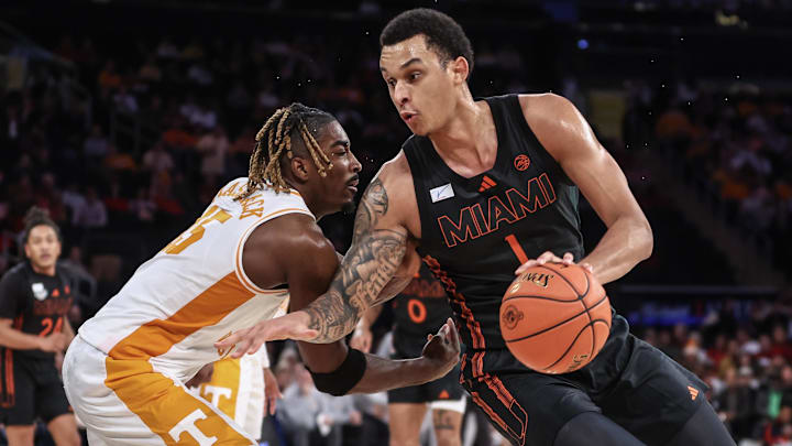 Dec 10, 2024; New York, New York, USA;  Miami Hurricanes center Lynn Kidd (1) looks to drive past Tennessee Volunteers guard Jahmai Mashack (15) in the second half at Madison Square Garden. Mandatory Credit: Wendell Cruz-Imagn Images