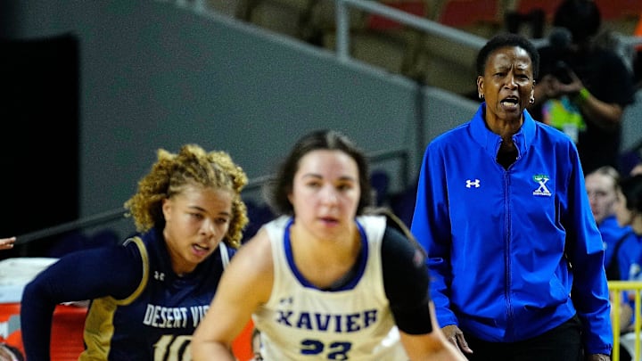Xavier Prep coach Jennifer Gillom yells to her guard Dominique Nesland (22) as she drives against Desert Vista during the Open State Championship game at Arizona Veterans Memorial Coliseum.