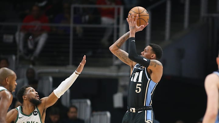 Mar 30, 2024; Atlanta, Georgia, USA; Atlanta Hawks guard Dejounte Murray (5) shoots against the