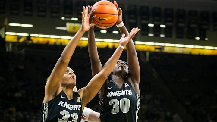 University of Central Florida forward Destiny Thomas, left, and Neila Luma go up for a rebound during a NCAA non-conference women's basketball game against Iowa, Saturday, Dec. 18, 2021, at Carver-Hawkeye Arena in Iowa City, Iowa.