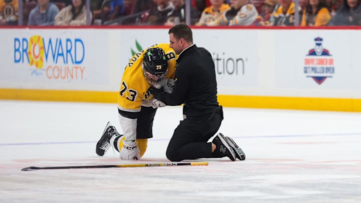 Feb 4, 2026; Sunrise, Florida, USA; Boston Bruins defenseman Charlie McAvoy (73) is looked at by a trainer after an apparent injury against the Florida Panthers during the first period at Amerant Bank Arena. Mandatory Credit: Sam Navarro-Imagn Images