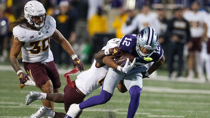 Nov 16, 2024; Manhattan, Kansas, USA; Kansas State Wildcats wide receiver Tre Spivey (12) is tackled by Arizona State Sun Devils defensive back Javan Robinson (12) during the fourth quarter at Bill Snyder Family Football Stadium. Mandatory Credit: Scott Sewell-Imagn Images
