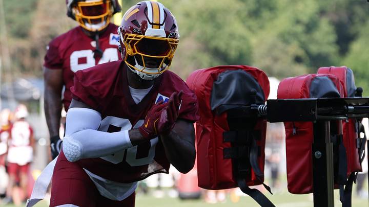 Ashburn, VA, USA; Washington Commanders defensive end Charles Omenihu (90) works on a blocking sled at training camp. At the BigBear.ai Performance Center at Commanders Park. Mandatory Credit: Geoff Burke-Imagn Images