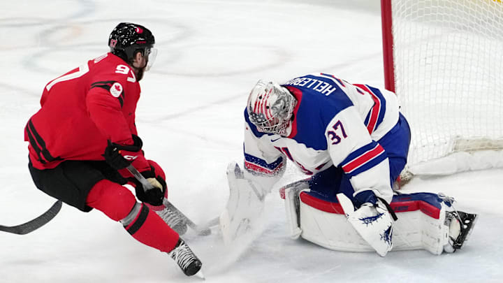 Feb 22, 2026; Milan, Italy; Connor McDavid of Canada shoots the puck against Connor Hellebuyck of the United States during the men's ice hockey gold medal game during the Milano Cortina 2026 Olympic Winter Games at Milano Santagiulia Ice Hockey Arena. Mandatory Credit: James Lang-Imagn Images Feb 22, 2026; Milan, Italy; Connor McDavid of Canada shoots the puck against Connor Hellebuyck of the United States during the men's ice hockey gold medal game during the Milano Cortina 2026 Olympic Winter Games at Milano Santagiulia Ice Hockey Arena. Mandatory Credit: James Lang-Imagn Images