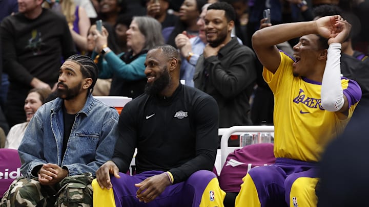 Jan 30, 2025; Washington, District of Columbia, USA; (L-R) Injured Los Angeles Lakers guard Gabe Vincent (7), Lakers forward LeBron James (M), and Lakers forward Rui Hachimura (R) react on the bench after a basket by Los Angeles Lakers guard Bronny James (not pictured) against the Washington Wizards in the fourth quarter at Capital One Arena. Mandatory Credit: Geoff Burke-Imagn Images