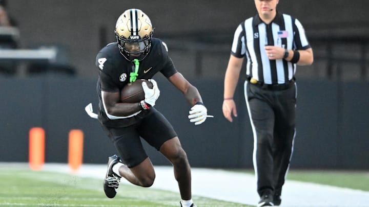 Aug 30, 2025; Nashville, Tennessee, USA;  Vanderbilt Commodores cornerback Martel Hight (4) runs with the ball against the Charleston Southern Buccaneers during the first half at FirstBank Stadium. Mandatory Credit: Steve Roberts-Imagn Images