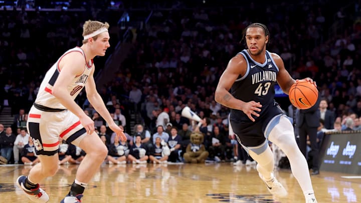 Mar 13, 2025; New York, NY, USA; Villanova Wildcats forward Eric Dixon (43) drives to the basket against Connecticut Huskies forward Liam McNeeley (30) during the first half at Madison Square Garden. Mandatory Credit: Brad Penner-Imagn Images