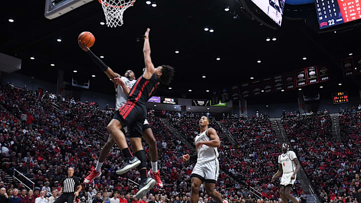 San Diego State Aztecs guard Micah Parrish (3) is fouled while going to the basket against UNLV Rebels forward Jalen Hill (1) during the first half at Viejas Arena. San Diego State Aztecs guard Micah Parrish (3) is fouled while going to the basket against UNLV Rebels forward Jalen Hill (1) during the first half at Viejas Arena.