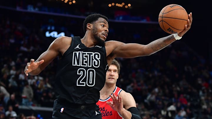 Jan 25, 2026; Inglewood, California, USA; Brooklyn Nets center Day'ron Sharpe (20) gets the rebound against Los Angeles Clippers center Brook Lopez (11) during the second half at Intuit Dome. Mandatory Credit: Gary A. Vasquez-Imagn Images