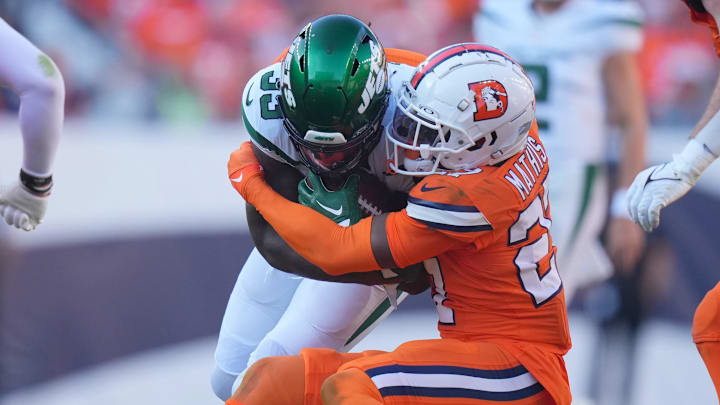 Denver Broncos cornerback Damarri Mathis tackles New York Jets running back Dalvin Cook.