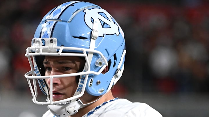 Nov 25, 2023; Raleigh, North Carolina, USA; North Carolina Tar Heels quarterback Drake Maye (10) watches the coin toss prior to a game against the North Carolina State Wolfpack at Carter-Finley Stadium. 