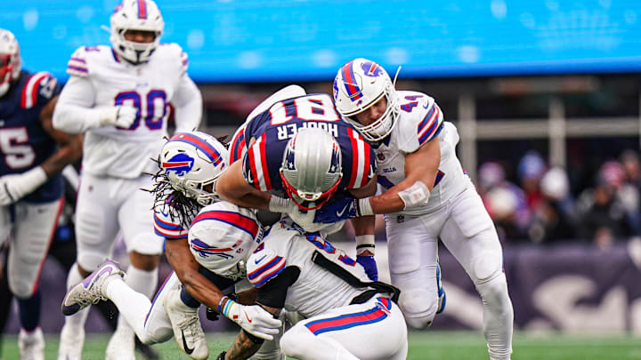 New England Patriots tight end Austin Hooper (81) runs the ball against Buffalo Bills safety Taylor Rapp (9) and linebacker Joe Andreessen (44) in the second quarter at Gillette Stadium. 