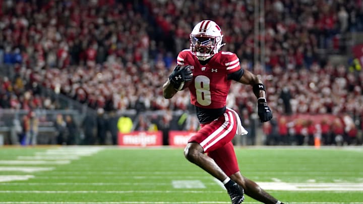 Nov 22, 2025; Madison, Wisconsin, USA; Wisconsin Badgers wide receiver Vinny Anthony II (8) runs the ball for a touchdown during the first quarter against the Illinois Fighting Illini at Camp Randall Stadium. Mandatory Credit: Kayla Wolf-Imagn Images