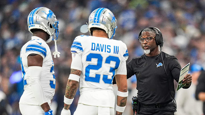 Detroit Lions defensive coordinator Aaron Glenn, right, talks to safety Kerby Joseph (31) and cornerback Carlton Davis III (23) during the first half against Indianapolis Colts at Lucas Oil Stadium in Indianapolis, Ind. on Sunday, Nov. 24, 2024.