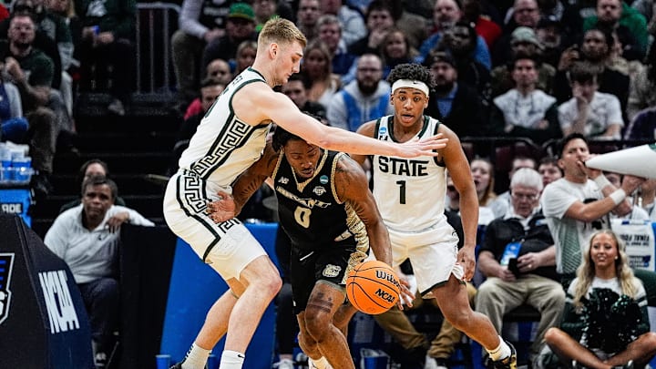 Michigan State center Carson Cooper (15) and guard Jeremy Fears Jr. (1) defend Bryant guard Earl Timberlake (0) during the first half of the First Round of NCAA Tournament at Rocket Arena in Cleveland, Ohio on Friday, March 21, 2025.