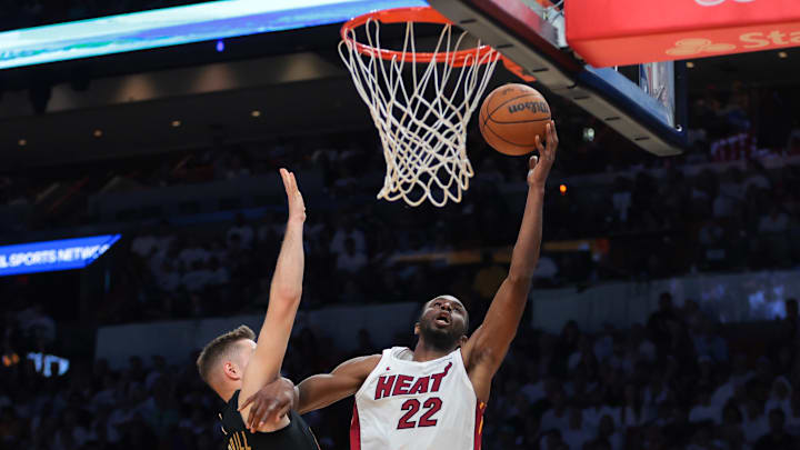 Apr 26, 2025; Miami, Florida, USA;Miami Heat forward Andrew Wiggins (22) drives to the basket against Cleveland Cavaliers guard Sam Merrill (5) in the third quarter during game three for the first round of the 2025 NBA Playoffs at Kaseya Center. Mandatory Credit: Sam Navarro-Imagn Images