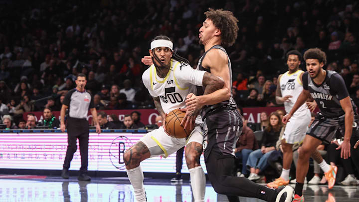 Dec 21, 2024; Brooklyn, New York, USA;  Utah Jazz guard Jordan Clarkson (00) controls the ball against Brooklyn Nets forward Jalen Wilson (22) in the third quarter at Barclays Center. Mandatory Credit: Wendell Cruz-Imagn Images