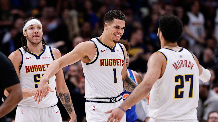 Mar 21, 2024; Denver, Colorado, USA; Denver Nuggets forward Michael Porter Jr. (1) reacts with guard Jamal Murray (27) ahead of forward Aaron Gordon (50) in the fourth quarter against the New York Knicks at Ball Arena. Mandatory Credit: Isaiah J. Downing-Imagn Images