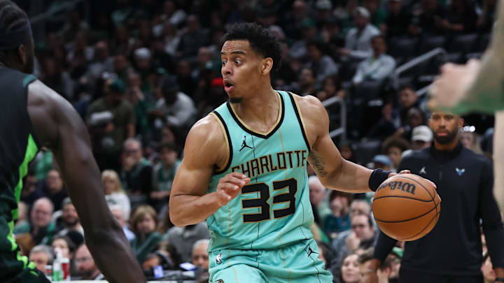 Apr 13, 2025; Boston, Massachusetts, USA; Charlotte Hornets guard Jaylen Sims (33) dribbles down the court during the second half against the Boston Celtics at TD Garden. Mandatory Credit: Paul Rutherford-Imagn Images