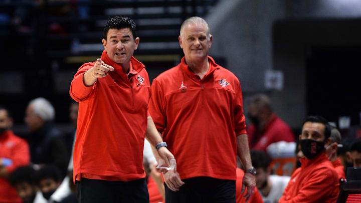 San Diego State Aztecs assistant coach David Velasquez (left) and head coach Brian Dutcher (center). San Diego State Aztecs assistant coach David Velasquez (left) and head coach Brian Dutcher (center).