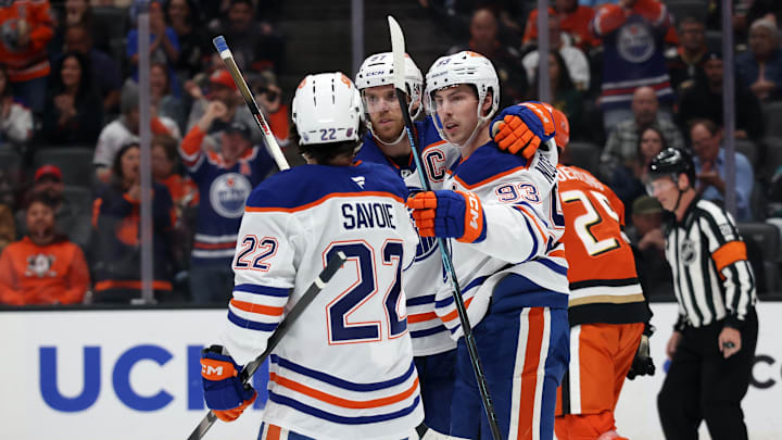 Feb 25, 2026; Anaheim, California, USA;  Edmonton Oilers center Ryan Nugent-Hopkins (93) celebrates with center Matt Savoie (22) and center Connor McDavid (middle) after scoring a goal during the first period against the Anaheim Ducks at Honda Center. Mandatory Credit: Kiyoshi Mio-Imagn Images