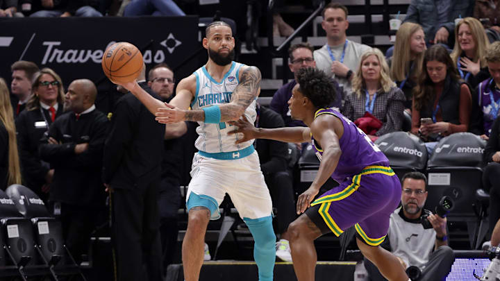 Feb 22, 2024; Salt Lake City, Utah, USA;  Charlotte Hornets forward Cody Martin (11) passes the ball away from Utah Jazz guard Collin Sexton (2) during the first quarter at Delta Center. Mandatory Credit: Chris Nicoll-Imagn Images