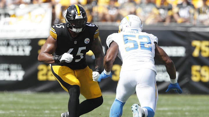 Sep 22, 2024; Pittsburgh, Pennsylvania, USA;  Pittsburgh Steelers offensive tackle Dan Moore Jr. (65) blocks Los Angeles Chargers linebacker Khalil Mack (52) at the line of scrimmage against at Acrisure Stadium. Mandatory Credit: Charles LeClaire-Imagn Images