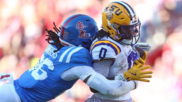 Sep 27, 2025; Oxford, Mississippi, USA; LSU Tigers wide receiver Zavion Thomas (0) runs after a catch as Mississippi Rebels linebacker Tahj Chambers (26) makes the tackle during the third quarter at Vaught-Hemingway Stadium. Mandatory Credit: Petre Thomas-Imagn Images Sep 27, 2025; Oxford, Mississippi, USA; LSU Tigers wide receiver Zavion Thomas (0) runs after a catch as Mississippi Rebels linebacker Tahj Chambers (26) makes the tackle during the third quarter at Vaught-Hemingway Stadium. Mandatory Credit: Petre Thomas-Imagn Images